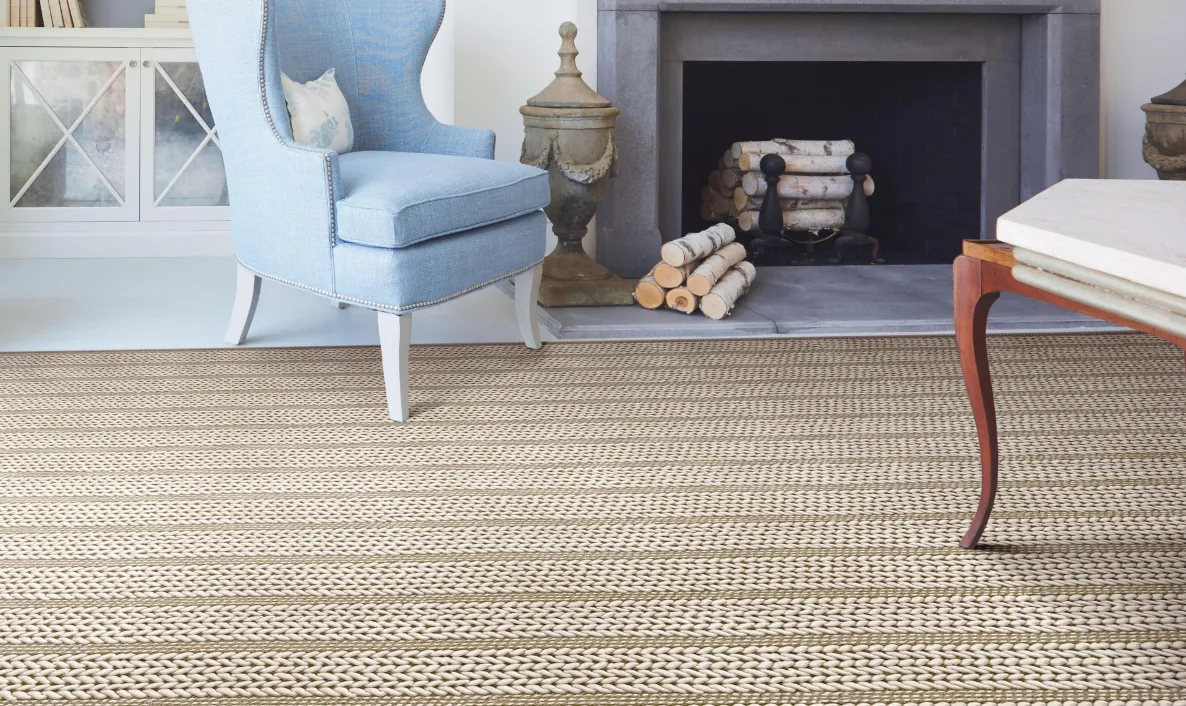 textured carpet in living room with fireplace