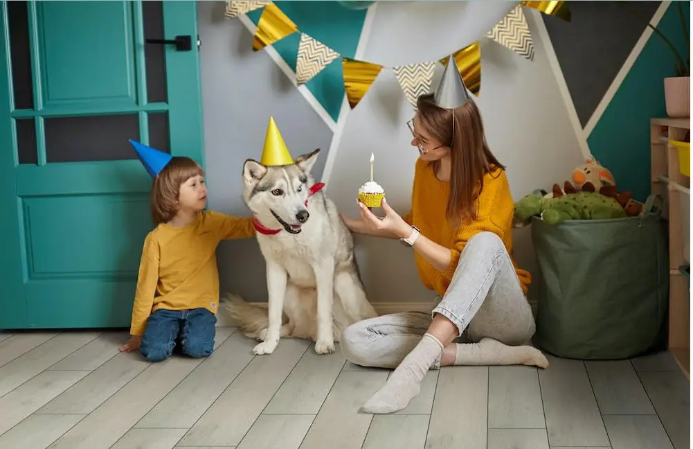 mom and child with dog at a party