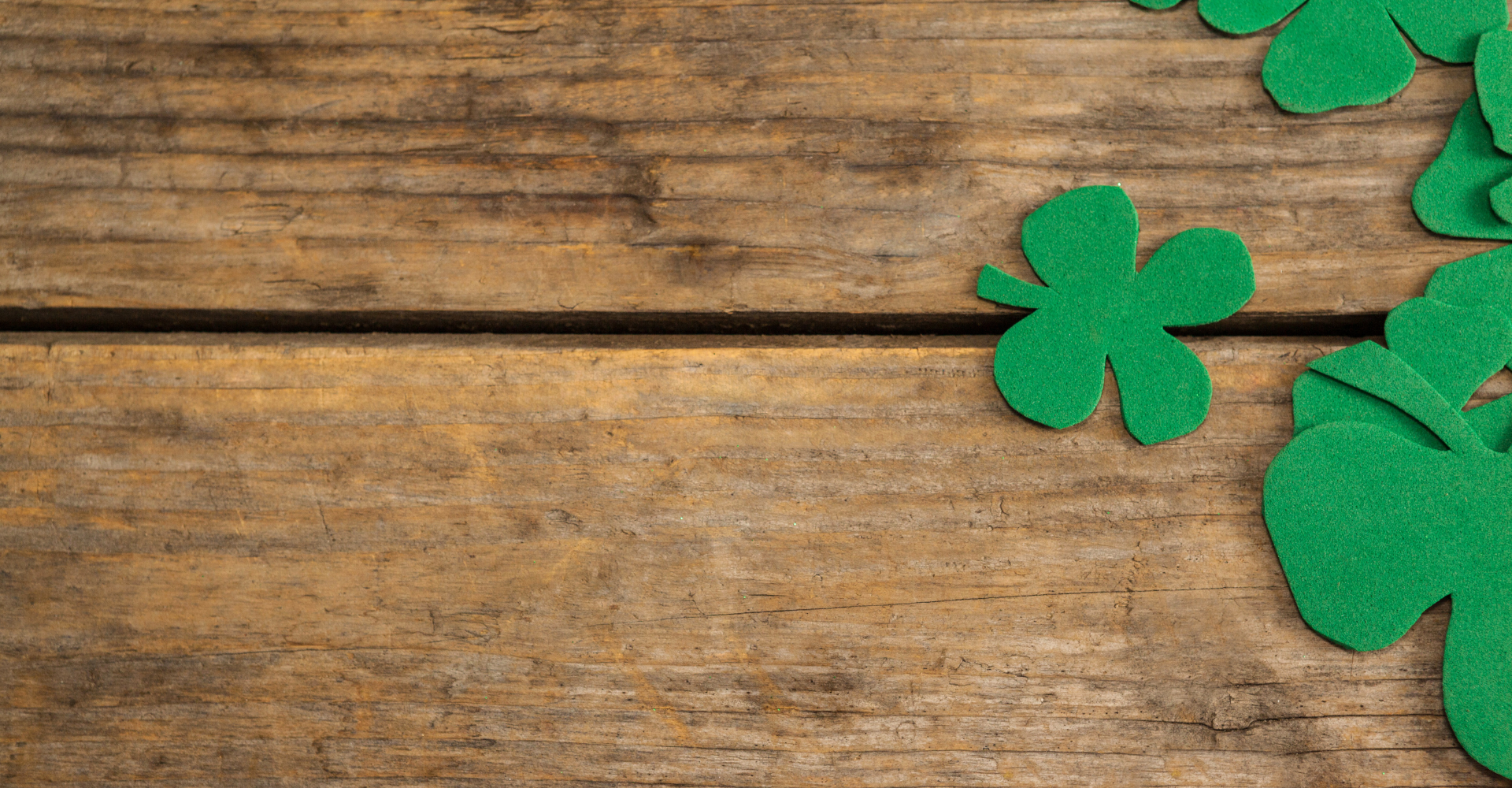 Woman sitting on a hardwood floor with a coffee mug in her hand.