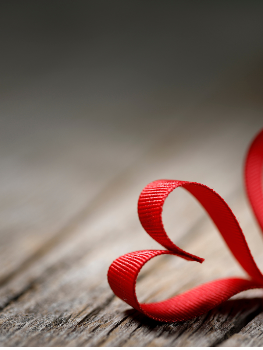 Woman sitting on a hardwood floor with a coffee mug in her hand.