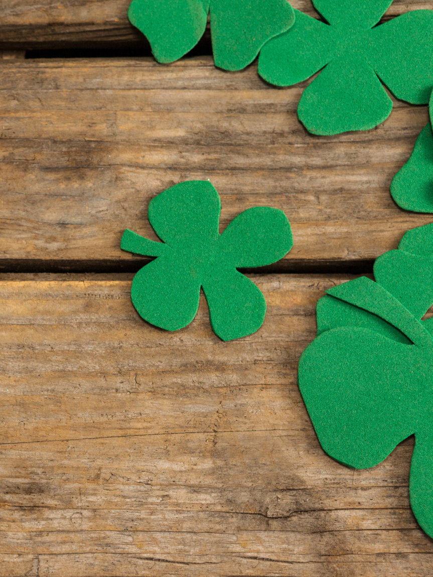 Woman sitting on a hardwood floor with a coffee mug in her hand.